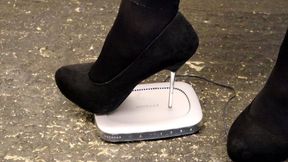 computer router crushed in black metal tipped stilettos