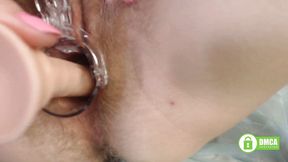 Toy in hairy  pussy opened with speculum