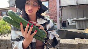 Horny brunette MILF with nice ass buys a couple of long cucumbers and then uses them as dildo
