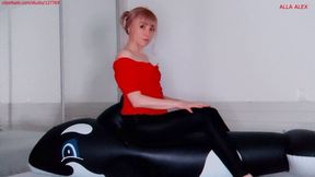 Alla sexily deflates a black inflatable whale with a loud hiss