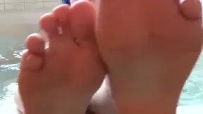 Hot beauty shows off her sultry feet in the bathtub