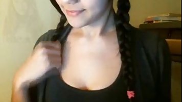 Long haired German brunette with huge black glasses is fingering her pussy in front of the camera