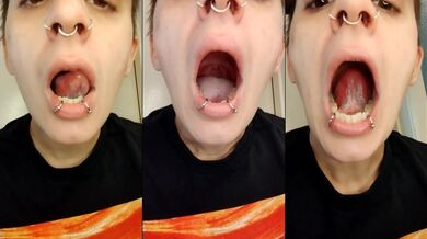 Her mouth stuffed with piercings and a long tongue