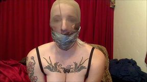 Professional dominatrix self-gagged and pantyhose hooded