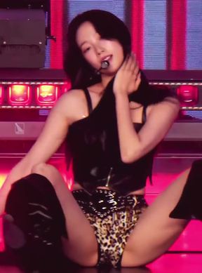 Sexy Asian woman in leopard print outfit sitting on stage