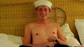 Sailor boy flashes a cute smile in a masturbation movie