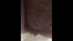 Hot, horny, hairy pussy taking a piss in the bathtub.