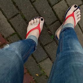 a crossdresser with sexy feet in flip flops is tempting on the street