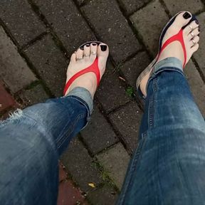 a crossdresser with sexy feet in flip flops is tempting on the street