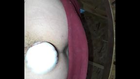 Straight amputee inserting 3 golf balls in ass