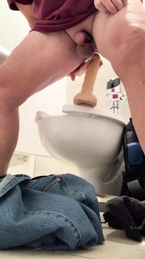 Get naked and fuck my dildo at a public toilet