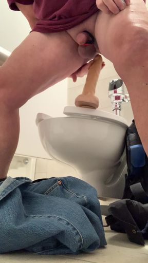 Get naked and fuck my dildo at a public toilet