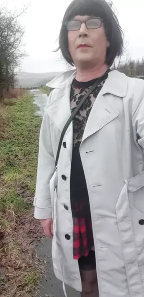 Crossdresser takes a walk on a windy lane