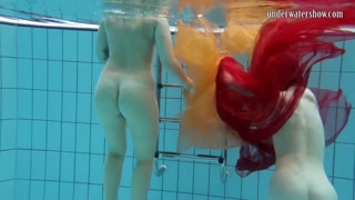 Two hotties submerged underwater