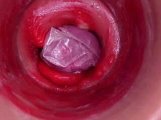 The camera inside the deep pussy records a huge ejaculation with a stuck condom