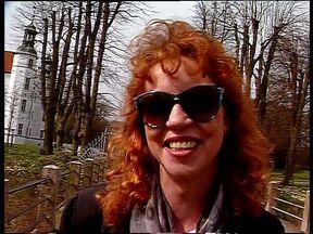 Redhead lady wearing sunglasses while giving an interview