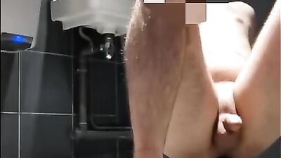 Kinky gay bud is stretching his asshole with a toy in the public restroom