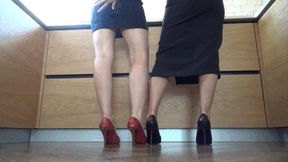 M Two air hostess who are girlfriends playing footsie in heels FS
