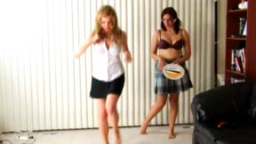 Two women electrifying game of Stripscotch with energetic jumps