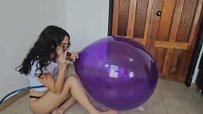 Inflating huge glass balloon then riding it and popping it