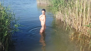 The girl goes completely naked out of the river