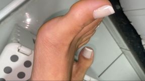 Doing number two in the bathroom with feet on the stool.