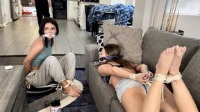 Rescue Us HD-Laney is bound and gagged by burglar Devyn while Peyton listens to music on her headphones