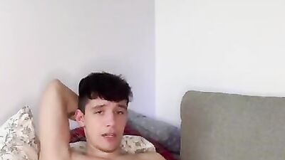 Cute twink playing with a bulge and jerks off his big cock and cums