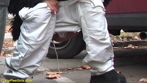 Girl peeing between the cars