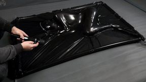 A girl in a small vacuum bed, with a vibrator and a clogged tube