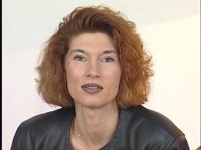 Tattooed ginger milf is filling her pussy with a big dildo