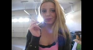 Blonde bitch smoking a cigarette in a close up video