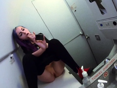 Wild babe fingering herself to climax in public toilet