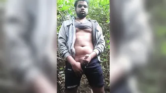 Hairy bear jerks his thick hard cock alone in the forest