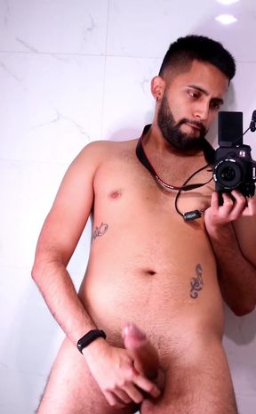 Horny latino stroking his big uncut dick in the mirror until he cums