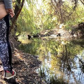 MILF dressed in leggings pissing in the river