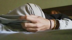 Young man pleasures himself in his bed