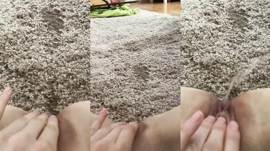 Thick warm piss soaks the carpet while she moans