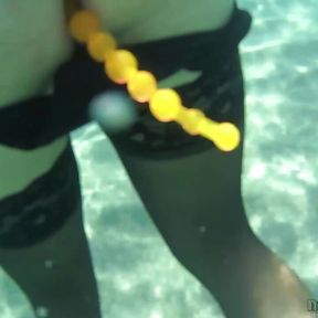 black stocking and anal beads in the sea