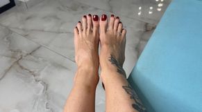 Long toes spreading, toe spread close ups in two different angles, bare feet with red toenails polish