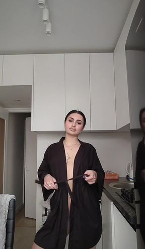 Woman in robe standing in kitchen