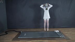 A lab accident or Sonya in a gray latex vacuum bed wearing a gas mask