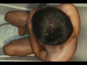 Hairy guy soaps up in bath, strokes, plays with his dick and foreskin and pisses on himself