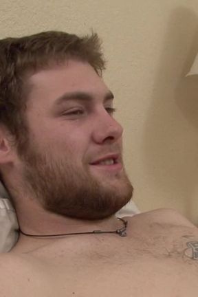 Tattooed dude gets his big dick sucked on the bed by his friend