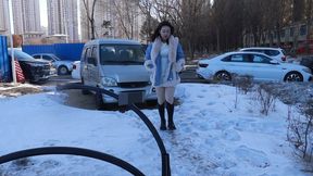 Chinese girl tickles outdoors in winter when it's too cold