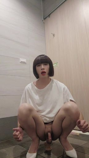 Shemale Ting Xuan Masturbating with a Dildo in a Public Toilet