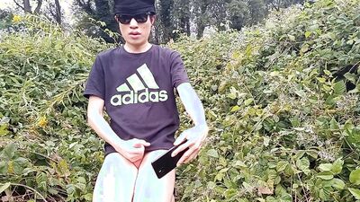 Jon Arteen, a gay Asian twink, is dressed in an Adidas t-shirt, hot pants, white socks, and Duramo sneakers. He jerks off
