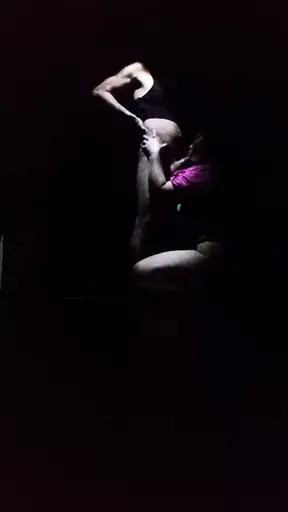 Blacked out couple dances under the moonlight