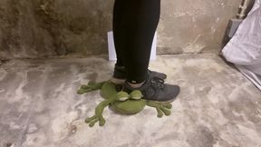 Crushing stuffed toy with sneakers