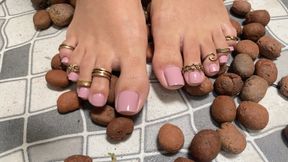 massaging feet on clay stones